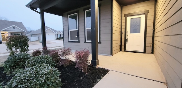 view of property exterior with a garage and a porch