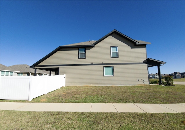 view of side of property with a lawn