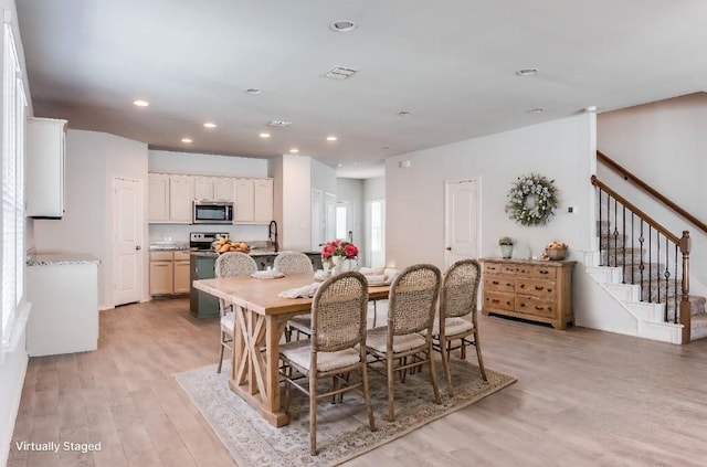 dining room featuring light hardwood / wood-style floors and sink