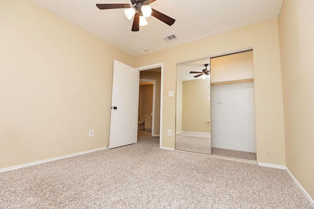 unfurnished bedroom featuring a closet, ceiling fan, carpet flooring, and a textured ceiling