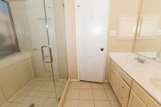 bathroom with tile patterned floors, walk in shower, and vanity