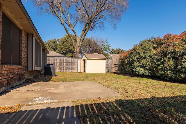 view of yard featuring a patio, cooling unit, and a storage unit