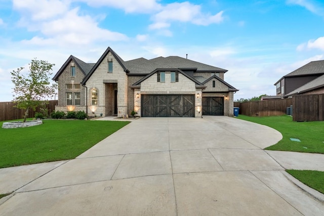 view of front facade with a garage and a front lawn