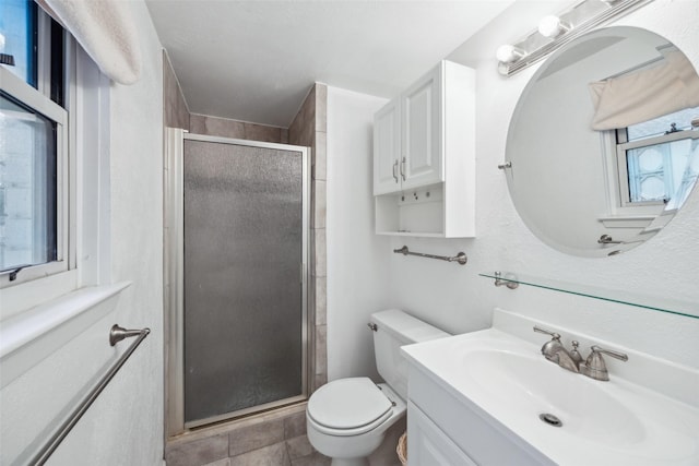 bathroom featuring vanity, toilet, and a shower with door