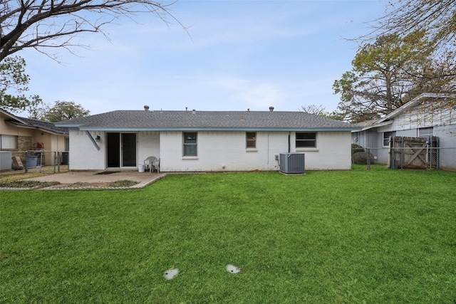 rear view of house featuring a yard, central AC, and a patio