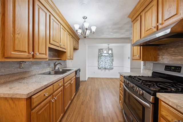 kitchen with pendant lighting, sink, dishwasher, an inviting chandelier, and gas stove