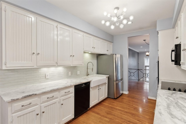 kitchen featuring black appliances, tasteful backsplash, white cabinetry, a chandelier, and sink