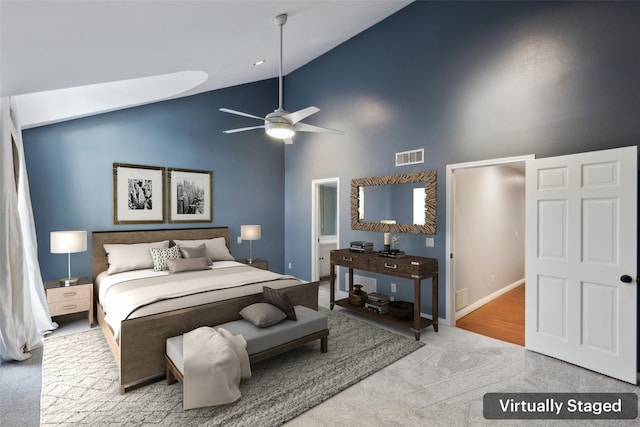 carpeted bedroom featuring ensuite bathroom, high vaulted ceiling, and ceiling fan