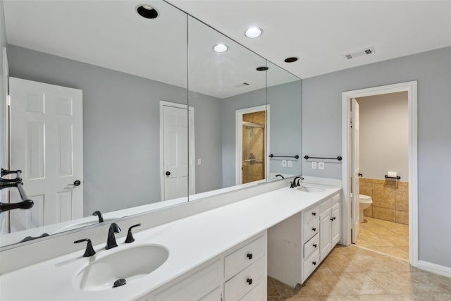 bathroom with toilet, tile patterned floors, and vanity