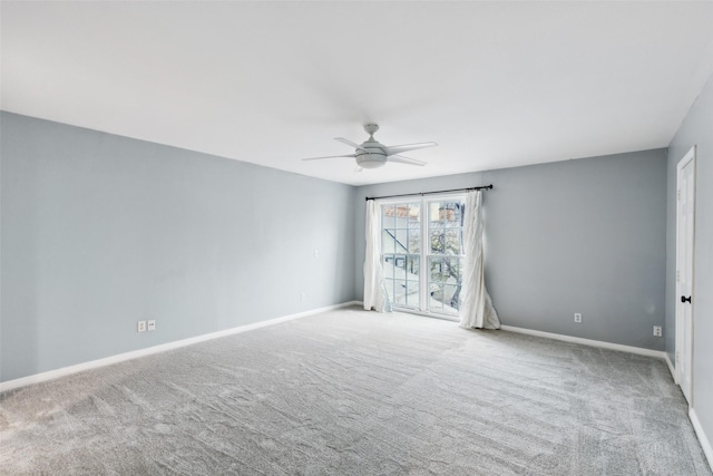 carpeted empty room featuring ceiling fan