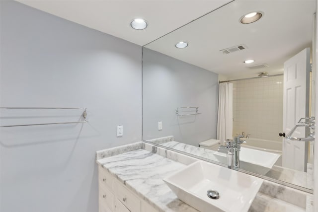 bathroom featuring vanity and shower / bath combination with curtain