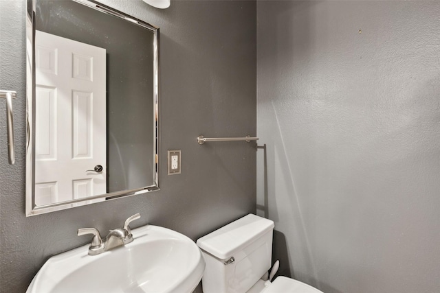 bathroom with sink and toilet