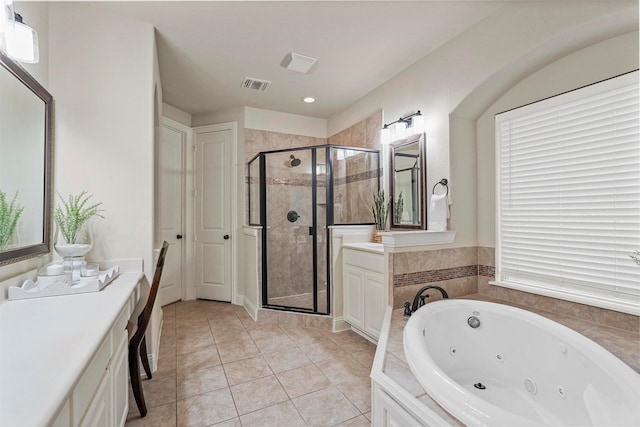 bathroom featuring independent shower and bath, tile patterned floors, and vanity