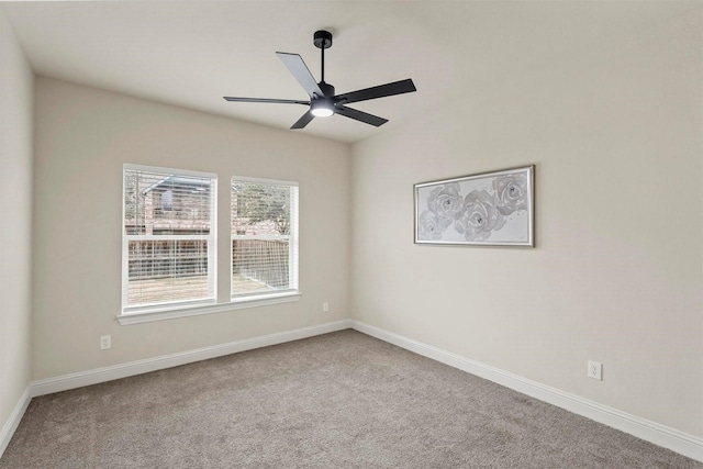 empty room featuring ceiling fan and carpet