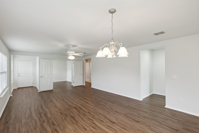 spare room with ceiling fan with notable chandelier and dark hardwood / wood-style floors