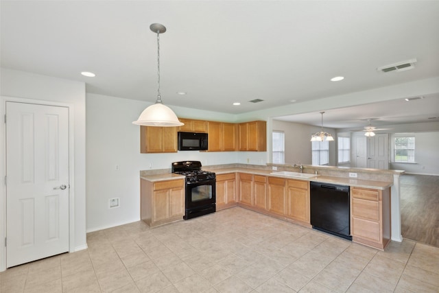 kitchen with black appliances, light tile patterned floors, sink, kitchen peninsula, and pendant lighting