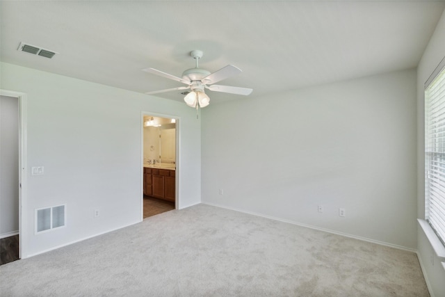 carpeted spare room featuring ceiling fan