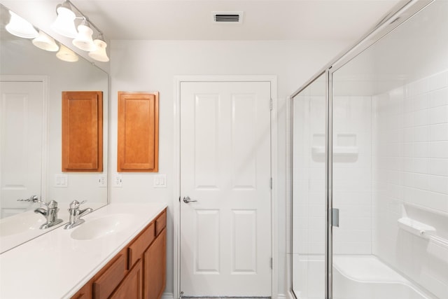 bathroom with walk in shower and vanity