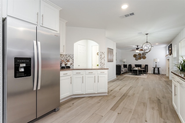 kitchen featuring backsplash, white cabinetry, stainless steel fridge with ice dispenser, and light wood-type flooring