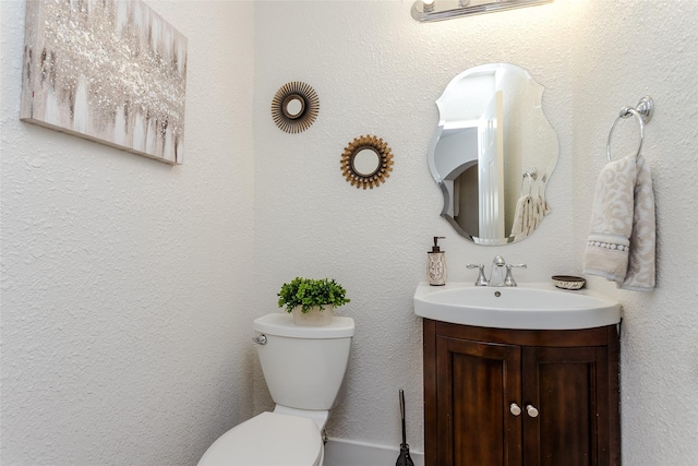 bathroom featuring toilet and vanity