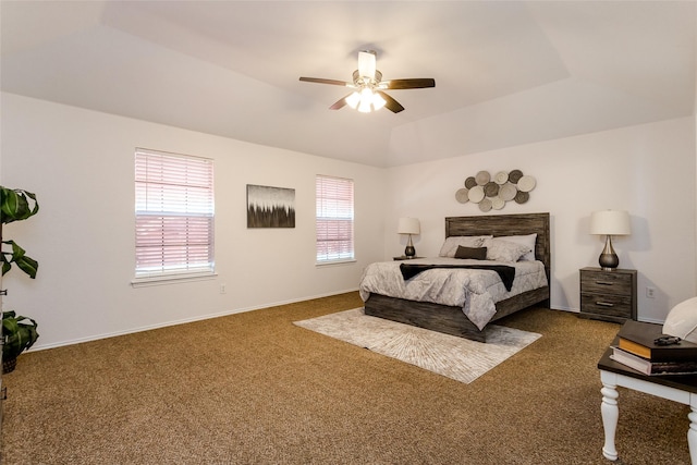 bedroom with ceiling fan, carpet, and a raised ceiling