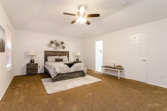 carpeted bedroom with ceiling fan and a tray ceiling