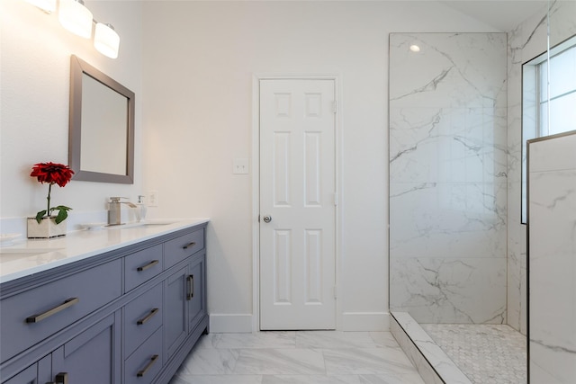 bathroom featuring tiled shower and vanity