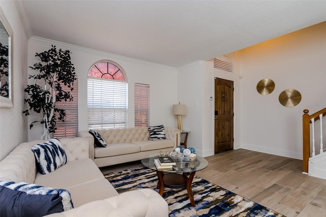 living room with ornamental molding and light wood-type flooring