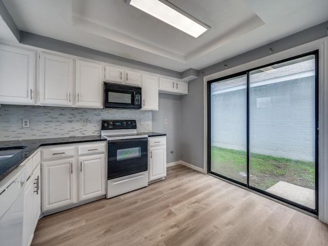 kitchen featuring light hardwood / wood-style floors, white cabinets, a raised ceiling, and white range with electric cooktop