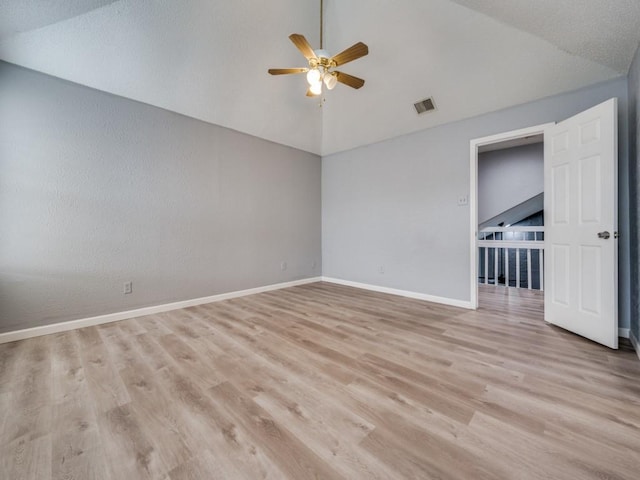 spare room featuring ceiling fan, light hardwood / wood-style flooring, and vaulted ceiling