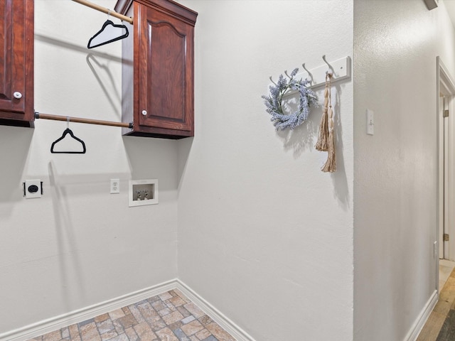 clothes washing area with cabinets, hookup for an electric dryer, and hookup for a washing machine