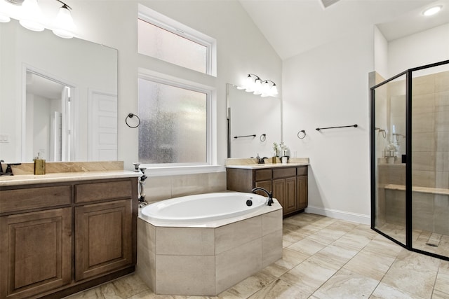 bathroom with vanity, lofted ceiling, and shower with separate bathtub