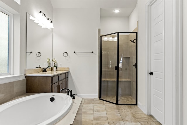 bathroom featuring plenty of natural light, vanity, and separate shower and tub