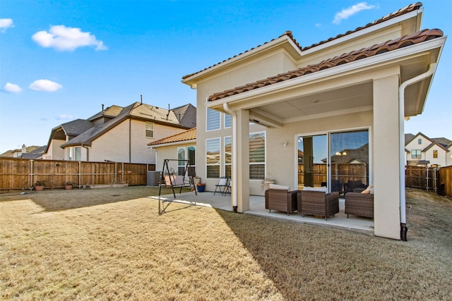 back of house featuring a patio and outdoor lounge area