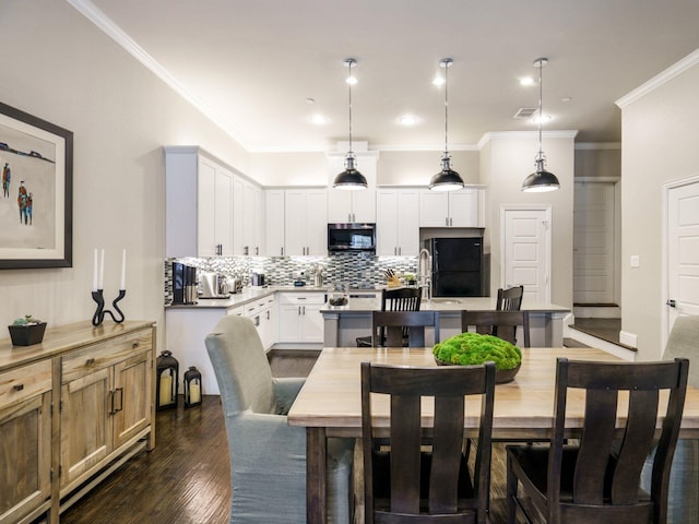 dining area with crown molding and dark hardwood / wood-style floors