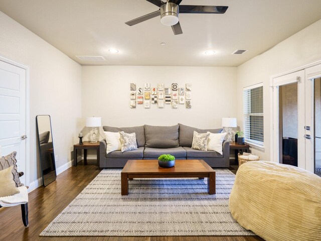 living room featuring dark wood-type flooring and crown molding