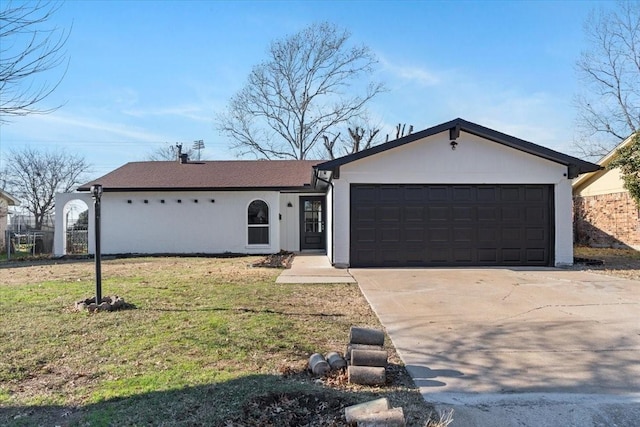 ranch-style home featuring a garage and a front lawn