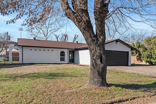 ranch-style house with a garage and a front yard