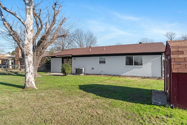 back of house with a yard and central AC