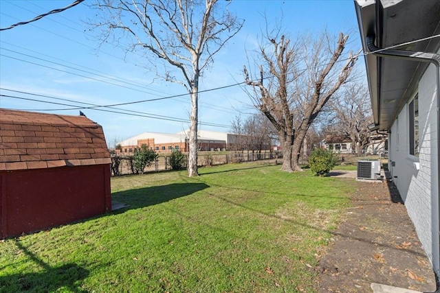 view of yard with a storage shed and central air condition unit