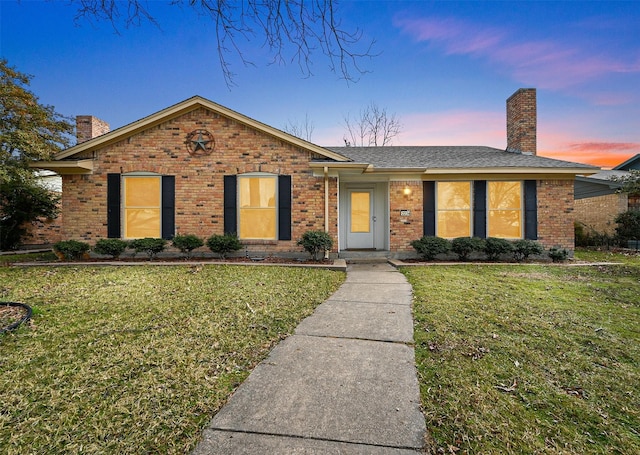 ranch-style home with a yard