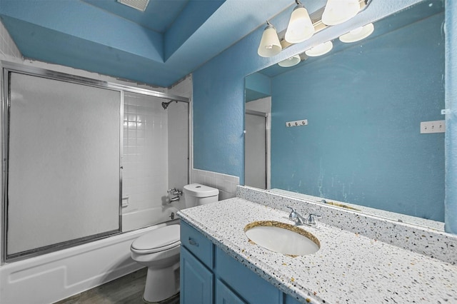 full bathroom featuring vanity, toilet, enclosed tub / shower combo, and wood-type flooring