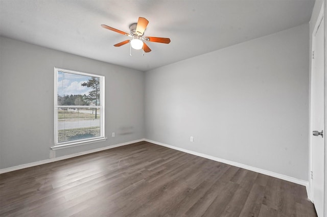 empty room with ceiling fan and dark wood-type flooring