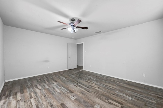 empty room featuring ceiling fan and dark hardwood / wood-style flooring