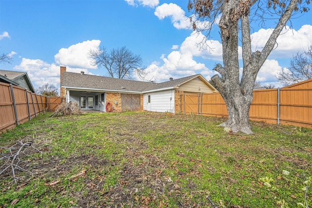 rear view of house with a yard