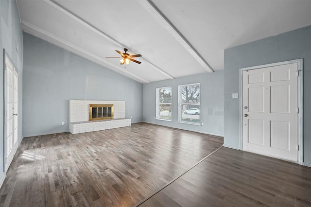 unfurnished living room with ceiling fan, dark wood-type flooring, vaulted ceiling with beams, and a brick fireplace