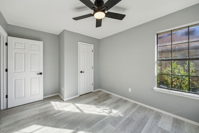 unfurnished bedroom featuring light hardwood / wood-style flooring, a closet, and ceiling fan