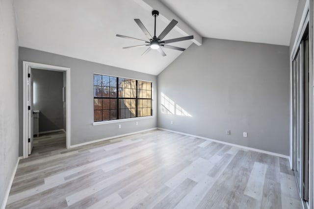 unfurnished bedroom with ceiling fan, light hardwood / wood-style flooring, and vaulted ceiling with beams