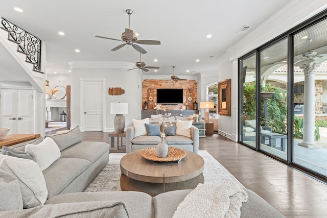 living room with a fireplace, wood-type flooring, and ornamental molding