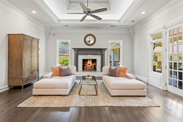 sitting room featuring crown molding, dark wood-type flooring, and a fireplace